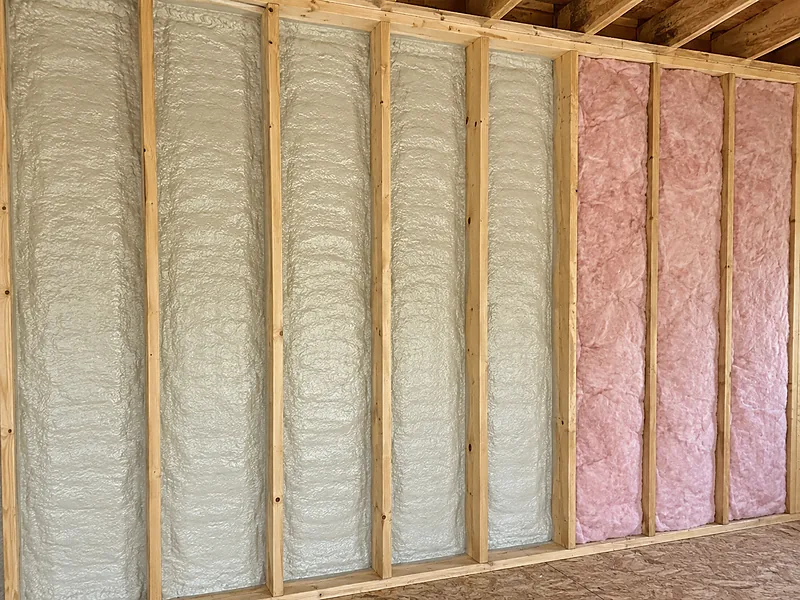 Spray foam and fiberglass batt insulation side by side in a framed wall